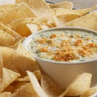 Spinach And Artichoke Dip · A creamy blend of spinach, artichokes, cream cheese and parmesan cheese.  Served hot with cr...