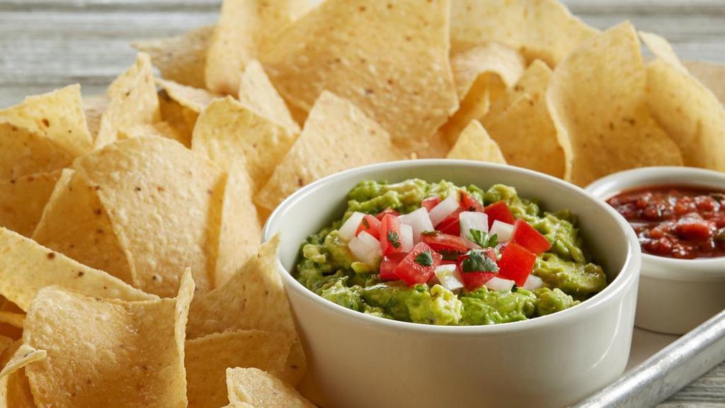 Housemade Guacamole And Chips · Our housemade guacamole is made fresh daily and is filled with chunky avocados, diced jalapeno and cilantro.  It’s mixed with our secret spices, topped with fresh pico de gallo and served with our crispy tortilla chips.