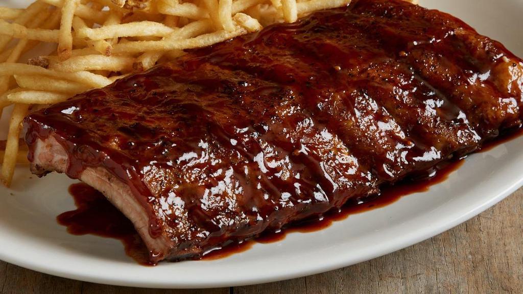 Half Rack Of Baby Back Ribs · Half rack of savory, fall-off-the-bone baby back pork ribs smothered in peppered BBQ sauce. Pick two of our classic sides to complement your entree.