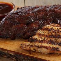 Baby Back Ribs And Chicken · Half rack of tender, fall-off-the bone baby back pork ribs, smothered in tangy peppered BBQ ...