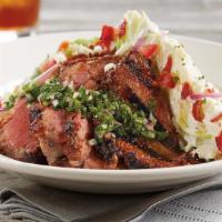 Tri-Tip Wedge* · We start with a crisp wedge of iceberg lettuce and top it with a slow-roasted, BBQ glazed, s...
