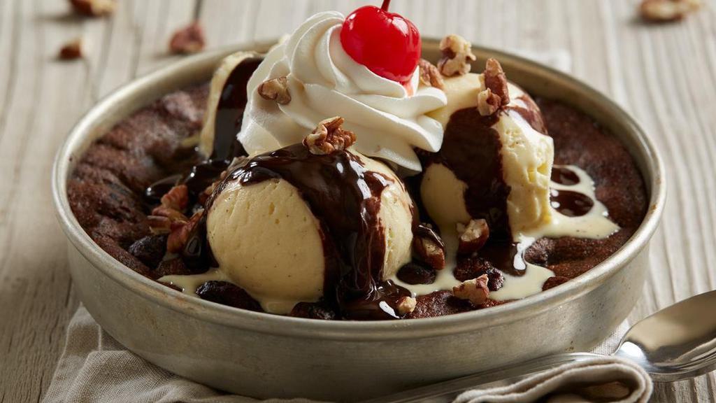 Bj'S Hot Fudge Brownie Pizookie ® · A warm, heavenly moist brownie topped with rich vanilla bean ice cream dripping with velvety dark chocolate hot fudge, toasted pecans, whipped cream and a cherry on top.