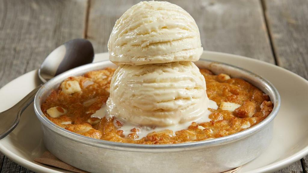 Bj'S White Chocolate Macadamia Nut Pizookie® · Indulge in this sweet and decadent white chocolate macadamia nut cookie topped with two scoops of our rich vanilla bean ice cream.