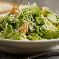 Caesar Salad · Crisp romaine lettuce tossed with seasoned, oven-baked croutons, shredded parmesan cheese an...