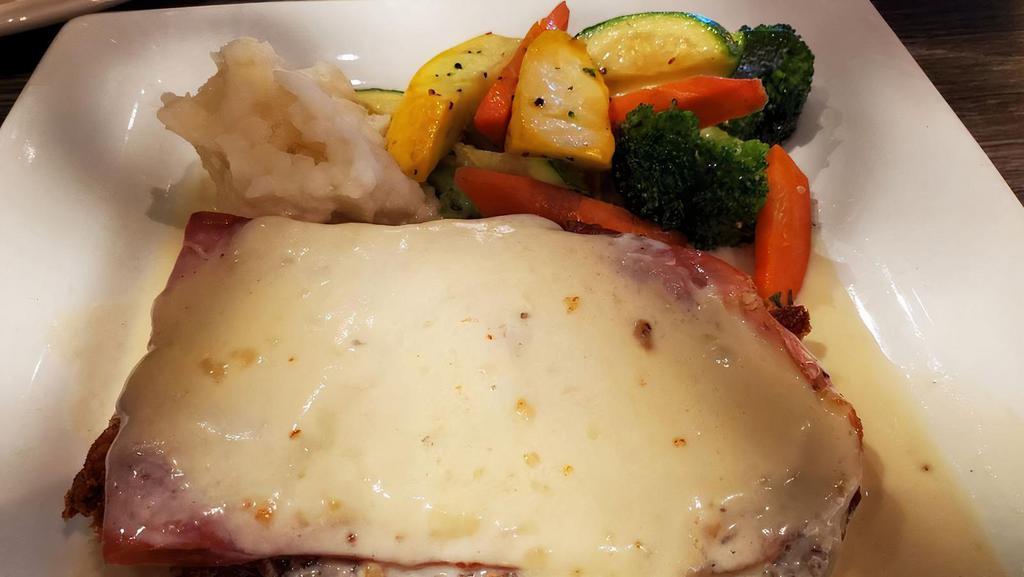 Pollo Capri Blu · Chicken breast stuffed with prosciutto and fresh mozzarella cheese, lightly breaded and baked, served in a rich Gorgonzola cream sauce. Served with mashed potatoes and vegetables.