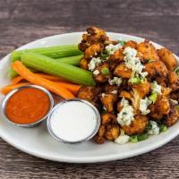 Crispy Buffalo Cauliflower · Cauliflower lightly battered in rice flour and breaded with Panko, topped with crumbled gorg...