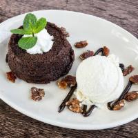Warm Chocolate Cake · Flourless Guittard chocolate cake topped with vanilla ice cream (optional), whipped cream & ...