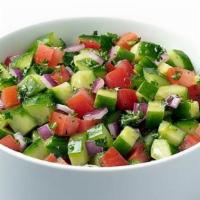 Cucumber Salad · Garden-fresh cucumbers, tomatoes, and red onion, tossed with zesty lemon juice and olive oil