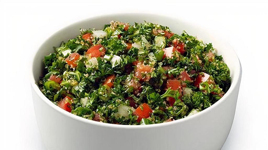 Tabbouleh Salad · Hand-chopped parsley and fresh mint leaves, finely diced onion and bulgur wheat, tossed with zesty lemon juice and olive oil