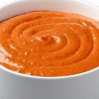 Harissa Hot Sauce · a housemade hot sauce, crafted with a  blend of roasted peppers and traditional spices