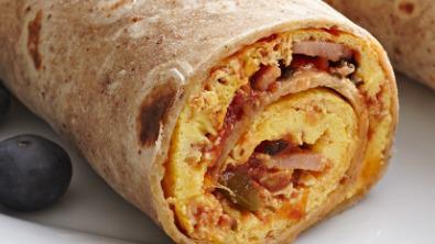 Ham Breakfast Burrito · The Ham Breakfast Burrito includes 
Ham,
Hashbrowns, 
3 scrambled eggs 
Shredded Cheddar and Monterey Jack cheese
Homemade Salsa on the side