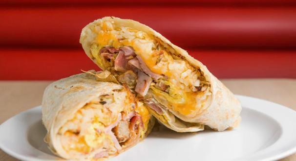 Breakfast Burrito · Our Breakfast burritos include; 
*Your choice of Bacon, Sausage or Ham
Hashbrowns
3 Eggs 
Shredded Cheddar and Monterey Jack Cheese