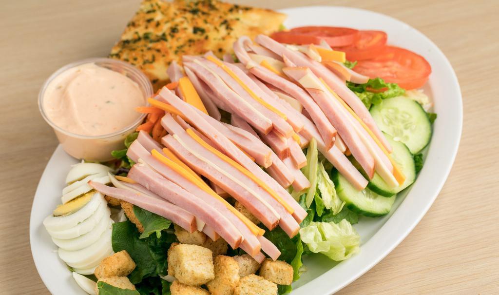 Chef Salad · Chef Salad Includes: 

Turkey 
Ham
American & Swiss Cheese
Romaine and Iceberg Lettuce mix
Shredded Carrots
Cucumber Slices
Sliced Tomatoes
Hard Boiled Egg
Croutons 
Shredded Cheese
Seasoned  Pita Bread.