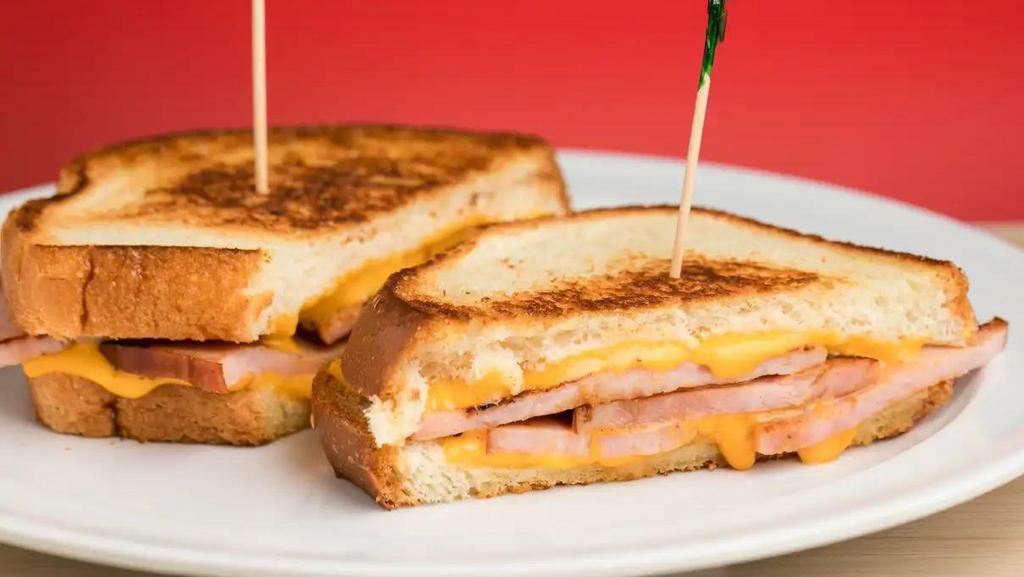Grilled Ham & Cheese · Grilled Ham & Cheese includes: 

Grilled Sourdough Toast,
Ham Slices,
2 Slices American Cheese,
2 Slices Swiss Cheese.