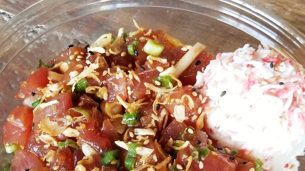 Classic Hawaiian · Raw.  Ahi tuna, crab salad, classic shoyu sauce, *macadamia nuts, green onions, white onions, and sesame seeds.