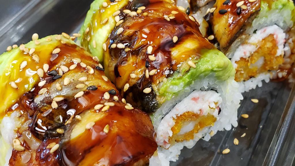 Dragon Roll · Cooked. Inside: imitation crab, panko shrimp.  On top: unagi (eel), avocado, sesame seeds.  Sauce: Unagi sauce.