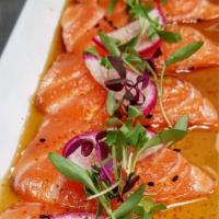 Salmon Carpaccio · Raw. 7 pieces thinly sliced Scottish salmon, mirco green, sesame seeds, Japanese seven spice...