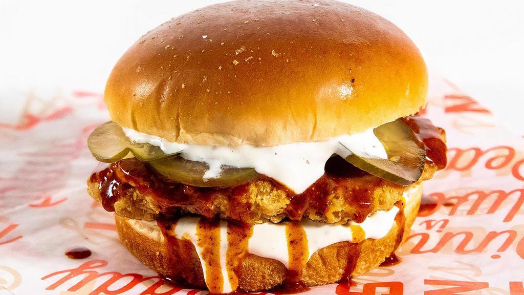 Nashville Hot Chicken Sandwich · Crispy Chicken Breast, topped with a smoky Nashville Hot sauce, pickles and Ranch dressing on a brioche bun.