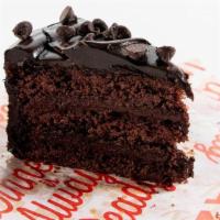 Deluxe Chocolate Cake · Rich chocolate cake covered in velvety chocolate icing sprinkled with chocolate chunks.