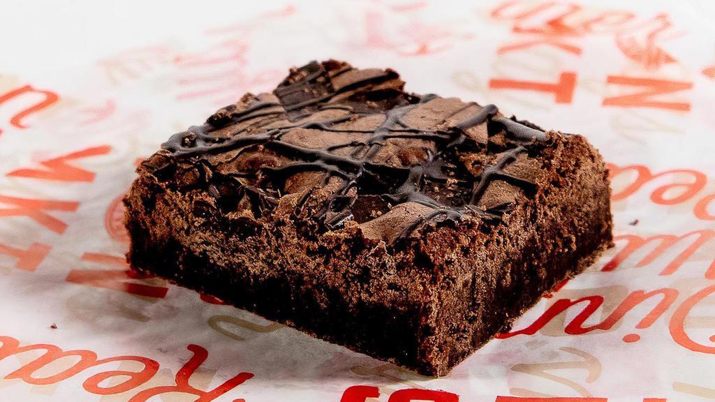Indulgent Chocolate Brownie · Traditional chocolate decadence  with chocolate chips bits throughout and striped on top.