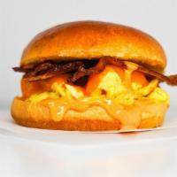 Brioche, Bacon, Egg, & Cheddar Sandwich · 2 scrambled eggs, melted Cheddar cheese, smoked bacon, and Sriracha aioli on a warm brioche ...
