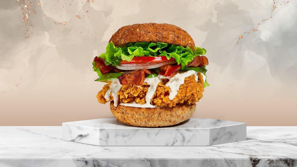 Avocado Bacon Club Crispy Chicken Sandwich · Buttermilk fried chicken, sliced avocado, applewood smoked bacon, lettuce, tomatoes, ranch, and mayo served on a toasted multigrain bun.