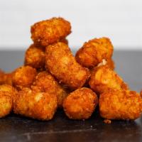 Side Of Spiced Tots · Crispy potato tots tossed in a medium heat spiced Nashville seasoning blend. Served with a s...