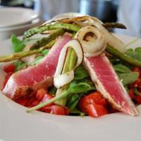 Seared Ahi Tuna Salad · Fresh Arugula, lightly seared Ahi Tuna, Grilled Asparagus, Caramelized Onions, Tomato Checca...