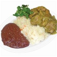Costillas En Salsa Verde · Beef ribs in green salsa with a side of rice and beans.