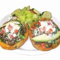 *Sopes · Handmade corn shell, toasted for texture, topped with beans, choice of meat, cilantro, onion...
