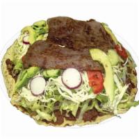 *Tlayuda · Tlayuda
Orden de 1 Unidad Tlayuda a large, thin, crunchy, toasted tortilla covered with a sp...