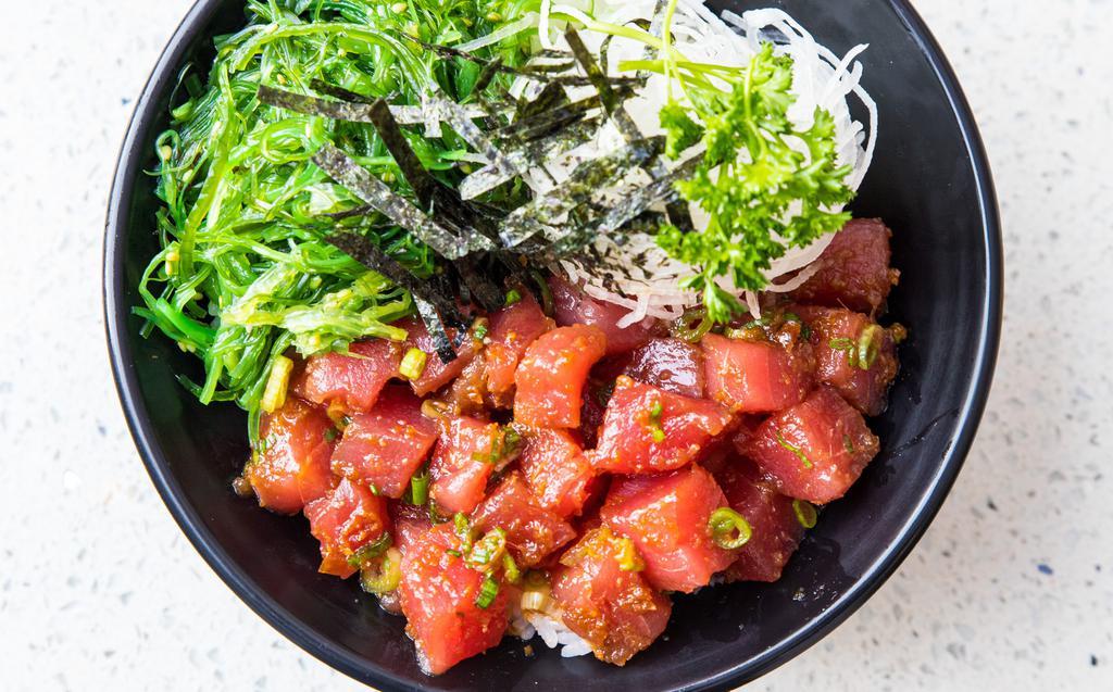Tuna Poke Bowl · Fresh tuna mixed in a Hawaiian poke dressing topped with green onions, served with seaweed salad.