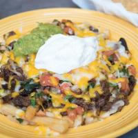 Asada Fries · Fries topped off with Carne Asada, Cheese, Pico De Gallo, Sour Cream, and Guacamole.