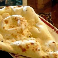 Naan · Popular tandoori bread made with fine white flour, milk, and eggs.