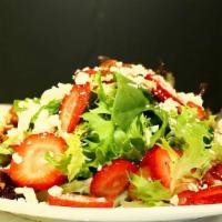 Strawberry Salad · Spring mix salad, strawberry slices, feta cheese, nuts, raspberry dressing, cucumber, tomato.