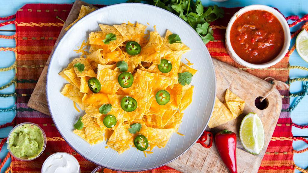 Nachos · Fresh nachos with guacamole, pico de gallo, sour cream, bean and cheese! Option to make it nacho fries as well!