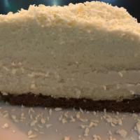 Vanilla Bean Cheesecake · Homemade vanilla bean cheesecake on graham crust topped with white chocolate mousse and shav...
