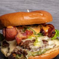 West Coast Burger · Angus beef, American cheese, applewood smoked bacon, guacamole, grilled onions, mayo, and le...