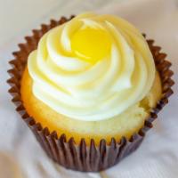 Lemon Drop Cupcake · Vanilla cake filled with lemon curd topped with lemon buttercream and a dollop of lemon curd.