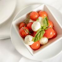 Caprese Salad · Cherry tomatoes with mozzarella, basil, extra virgin olive oil, salt and pepper