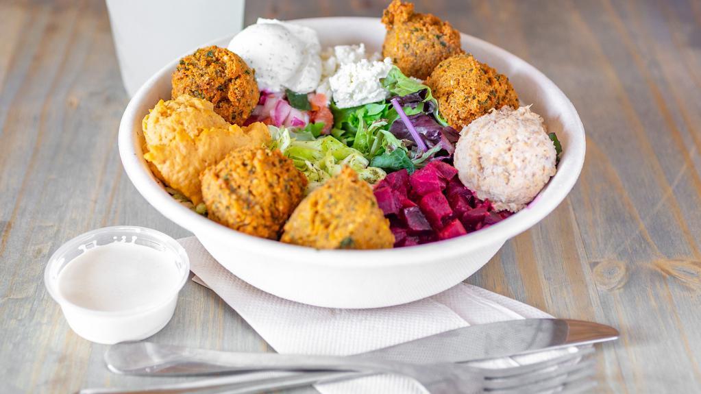 Falafelicious · Mixed greens, kalamata hummus, spicy hummus, tzatziki, falafel, white cabbage, chopped salad, beets, feta cheese, tahini. Add souvlaki chicken (Chicken breast, lemon, and sour cream), Add Spicy Beef (Grilled steak strips with chili) & Add Chicken Gyro for an additional charge.