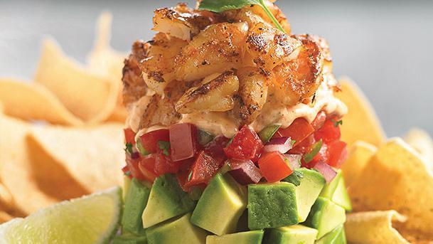 Fresh Avocado & Shrimp Stack · Marie's Callender's signature item.  Fresh avocado. Pico de gallo and spicy chipotle ranch dressing layered and topped with Cajun-grilled shrimp. Served chilled with crispy tortilla chips. 550 cal.