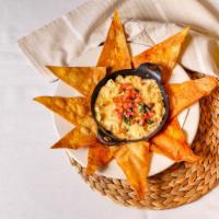 Cheesy Spinach & Artichoke Dip · Three-cheese artichoke dip served hot and topped with pico de gallo and melted parmesan chee...