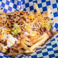 Super Fries · Carne Asada Super Fires with Beans, Guacamole, Sour Cream and Cheese.