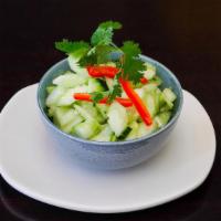 Cucumber Salad · Sliced cucumber topped with chili, onions, and vinaigrette dressing.