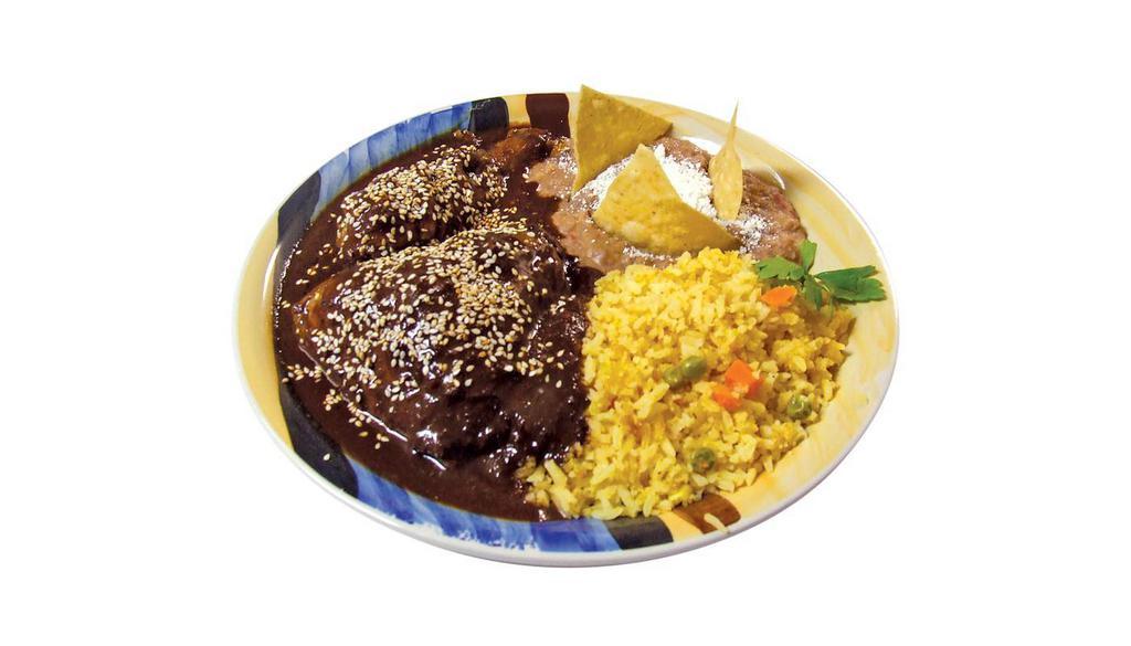 Mole Poblano · Authentic Mexican Mole sauce served with chicken accompanied with red rice, refried beans and hand made tortillas.
