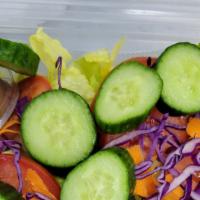 House Salad · Lettuce, shredded carrots, Cucumbers, tomatoes and red cabbage with vinaigrette dressing.