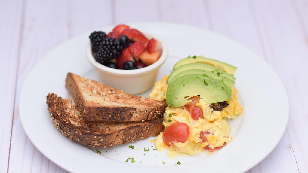 California Scramble · Uncured applewood bacon, tomatoes, spinach, cheddar, avocado. toast and breakfast side.