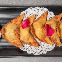 Cheesy Spinach Wontons · Crispy fried wonton skins stuffed with spinach, water chestnuts and cream cheese. Served wit...