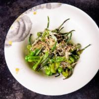 Shishito Peppers · Shishito Peppers tossed in ponzu butter and bonito flakes.